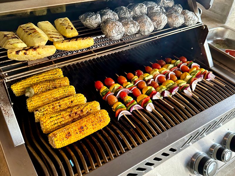 Corn, vegetable skewers and potatoes on the grill for a family-style BBQ in a Guanacaste villa