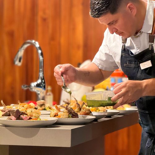 Chef Fabián Argüello plating dinner in a villa kitchen